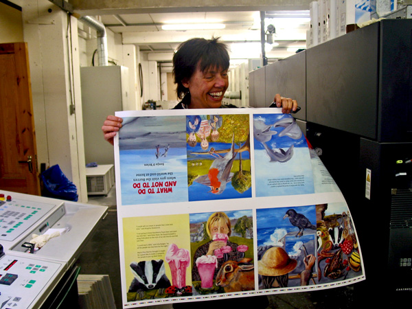 sonja o'brien holds up the first print from her new book